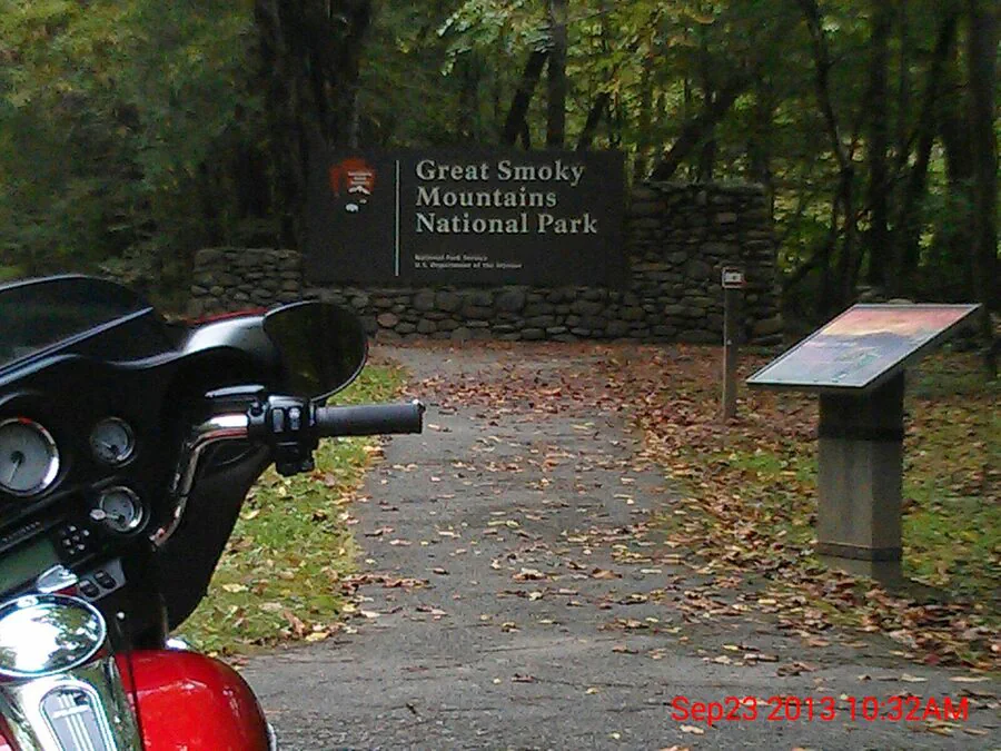 Great Smoky Mountains National Park sign beside the road.