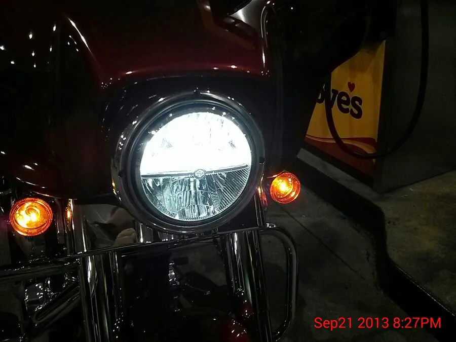 Close-up of the motorcycle’s round LED headlight.